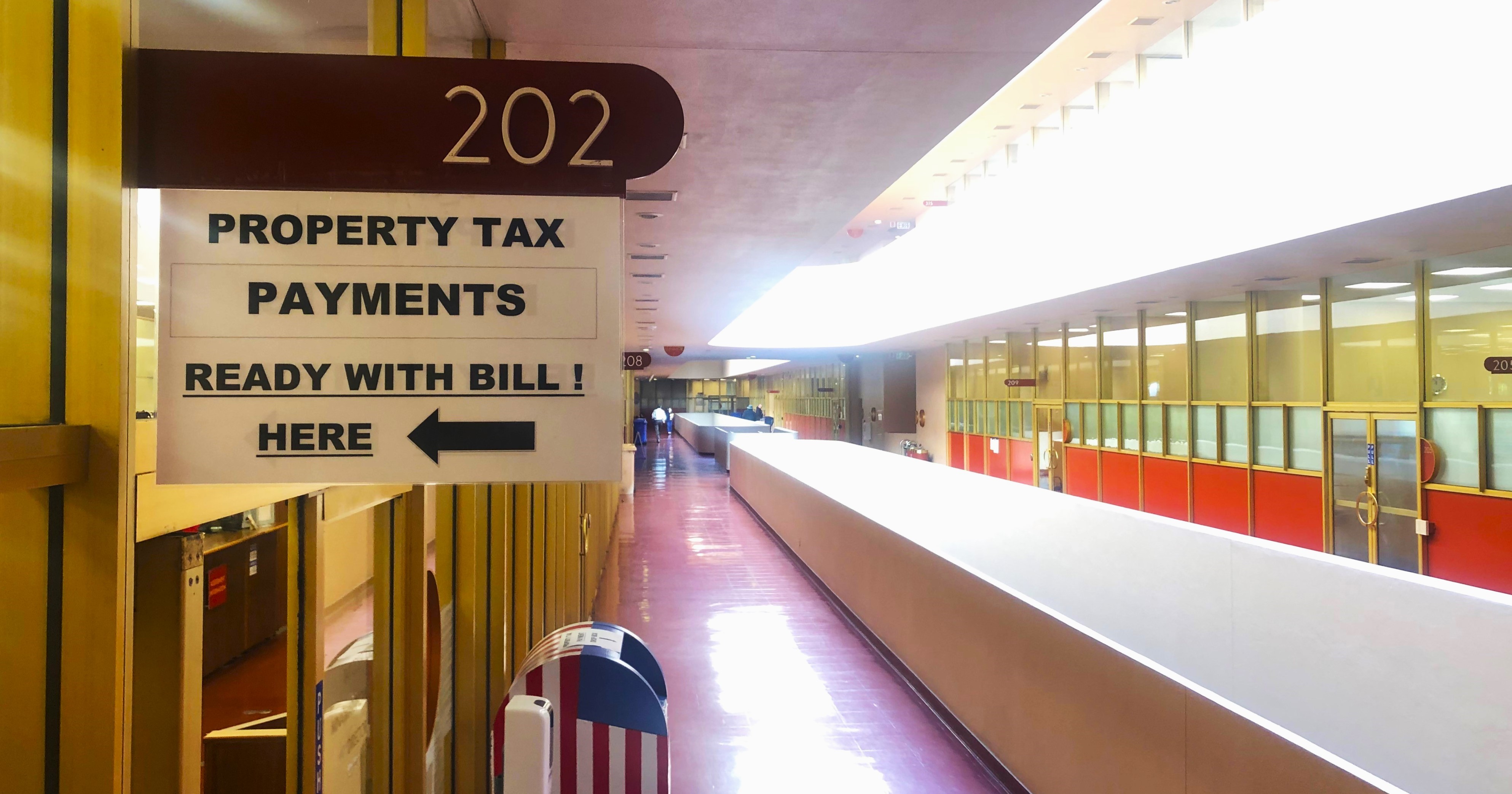 A closeup view of the sign at the Civic Center that says Room 202, Property Tax Payments.