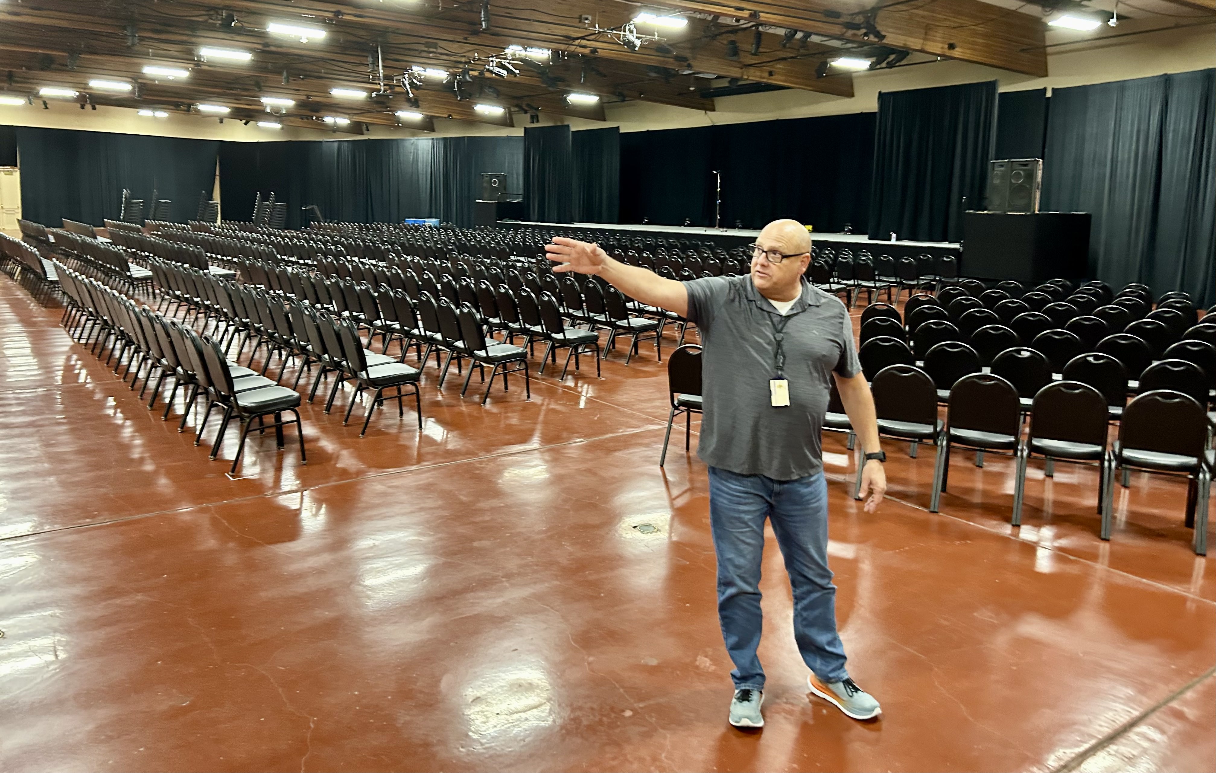 Veterans Services Officer Sean Stephens gestures inside Exhibit Hall, where the Memorial Day event will be. 